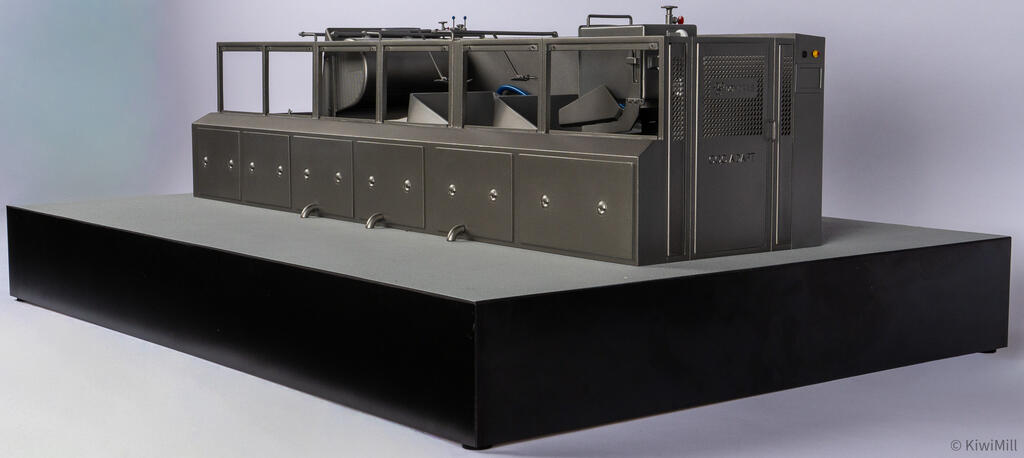 Low view of the cooking line model's discharge end cabinet with perforated door panel and orange indicator light